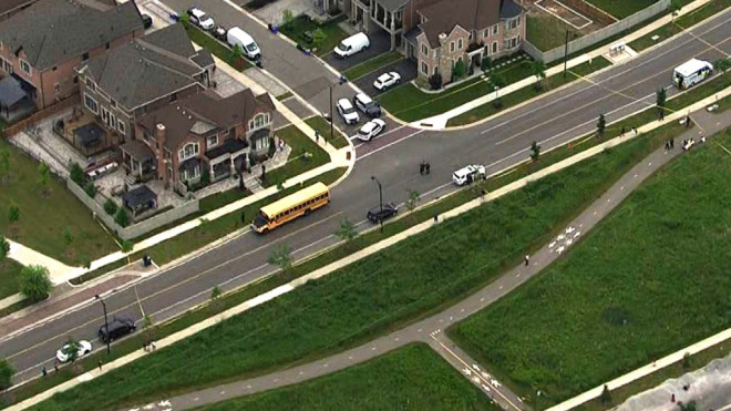 In this aerial view from the CTV News helicopter, a school bus involved in the incident is seen in Vaughan, Ont., Wednesday, June 19, 2024.