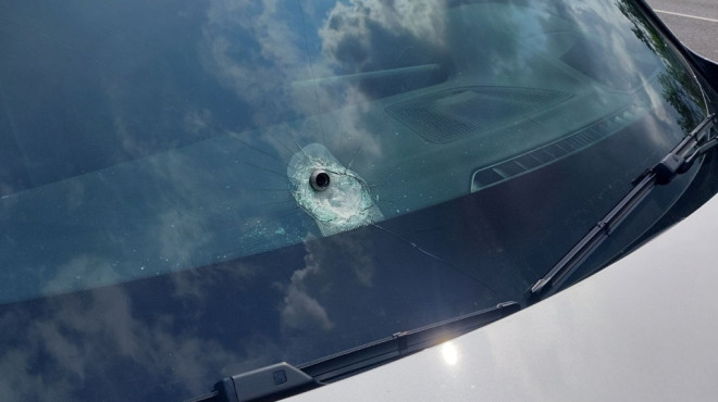 A nut from a loose wheel lodged in the windshield of another vehicle travelling along Highway 400 in Innisfil, Ont., on Thurs., July 25, 2024. (Source: OPP)