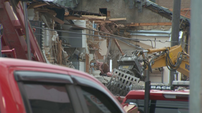 Crews dismantle parts of a compromised Toronto building on Aug. 17, 2024.