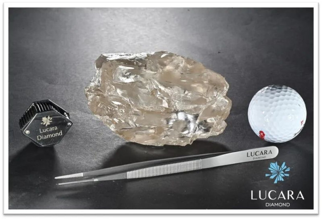 The as-of-yet-unnamed diamond photographed beside a golf ball and other objects to show its scale.