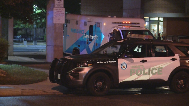 Toronto police are pictured next to an ambulance after a shooting victim was transported to hospital from the area of Kingston and Markham roads Saturday September 21, 2024.(Jacob Estrin /CTV Toronto)