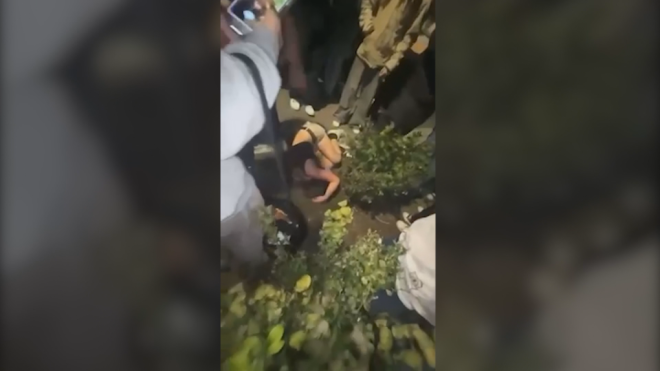 The video shows a young girl being swarmed by dozens of teens and beaten to the point of unconsciousness.