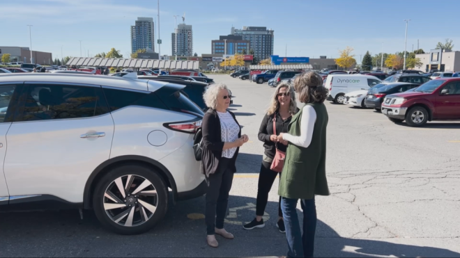 Madeleine Gervais (left) speaks with her daughters in the parking lot at College Square in Ottawa. (Kimberley Johnson/CTV News Ottawa)