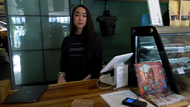 Julianna Tan runs a small store on 20th Street. She says someone recently hurled a brick through her front window, November, 2024. (Carla Shynkaruk / CTV News)