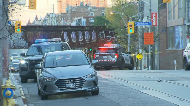 Policer cruisers are shown at the scene of a shooting investigation on Queen Street West on Nov. 12, 2024.