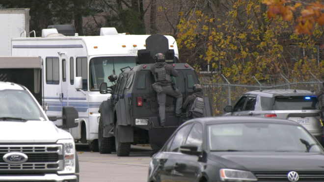 Police tactical vehicles ram a white camper in a parking lot, barricading an allegedly active shooter in Barrie Ont., on Nov. 19, 2024. (CTV News/ Mike Arsalides) 