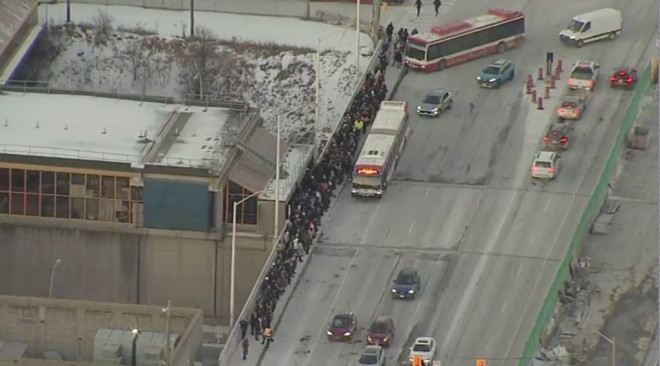 TTC riders wait in the cold for shuttle buses at Lawrence West station on Jan. 22, 2025