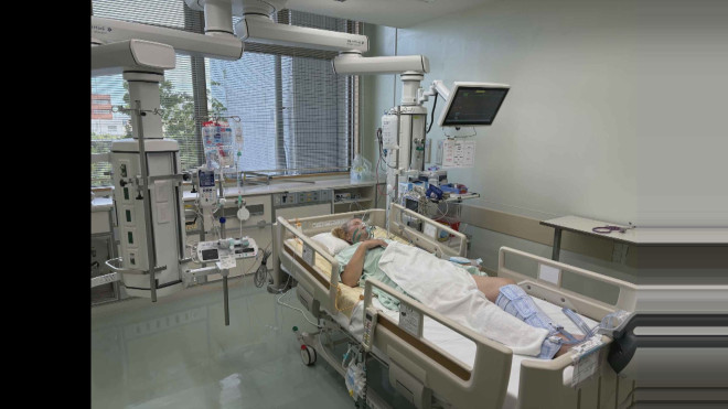 A photo of Dione Amundson as she lays in a hospital be in Japan after suffering a perforated intestine.