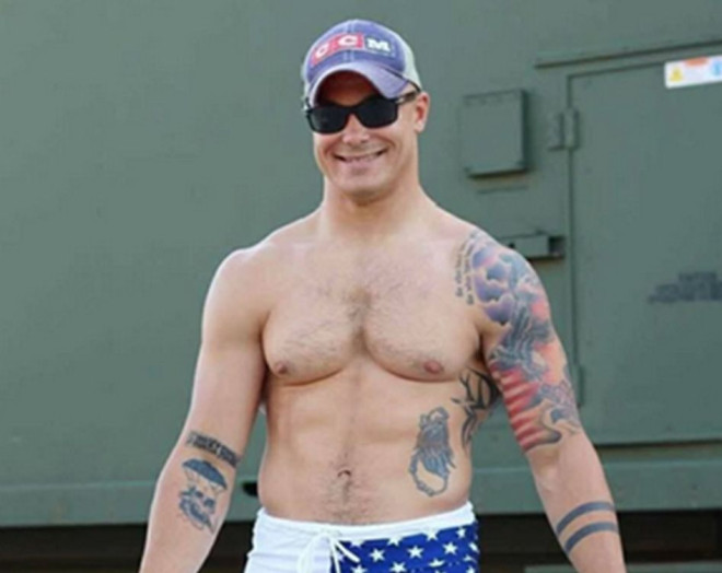 Travis Decker, along with his unique tattoos, can be seen in this police handout.