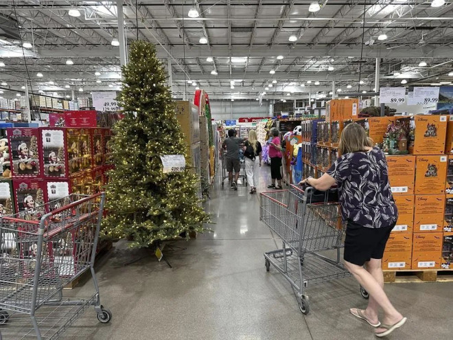 FILE - A shopper passes a Christmas tree costing $600 on display in a Costco warehouse Sept. 12, 2024, in Thornton, Colo. (AP Photo/David Zalubowski, File).