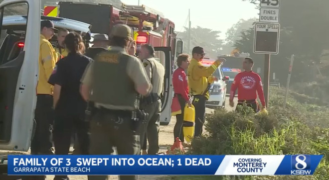 Life guards and first responders stand near the state beach after a father drowned attempting to save his daughter from a 15 foot wave.