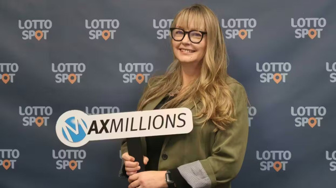 lotto max winner Sandra Mogdan holding maxmillions sign