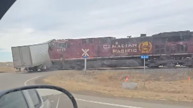 This image, taken from a video shot by Global News viewer John Dyck, shows a train colliding with a semi truck, near Taber on Tuesday.