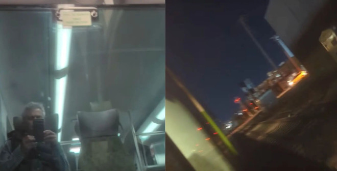 电梯内部反光表面和一名拍照者，突出城市交通环境。